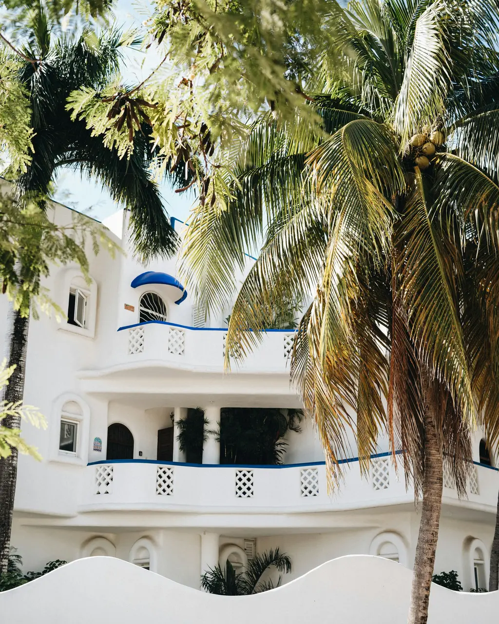 Multi-level white villa with palm trees in Playa del Carmen