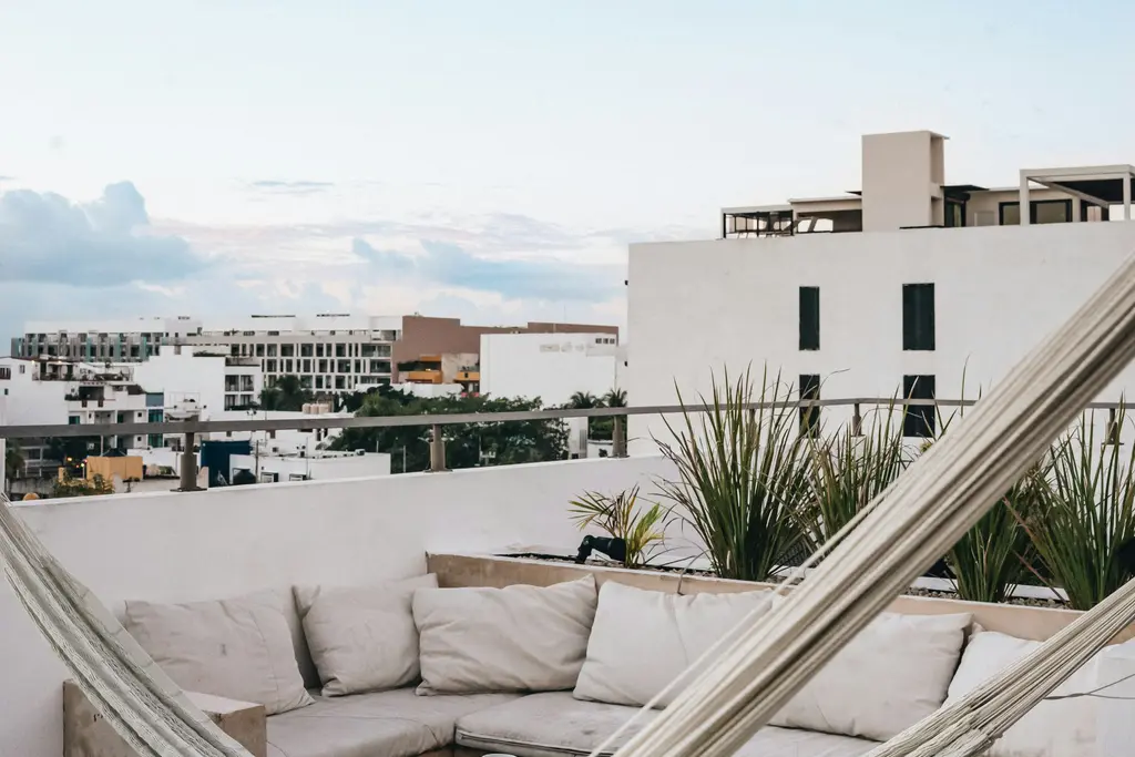 Rooftop terrace with hammock and outdoor lounge in Playa del Carmen