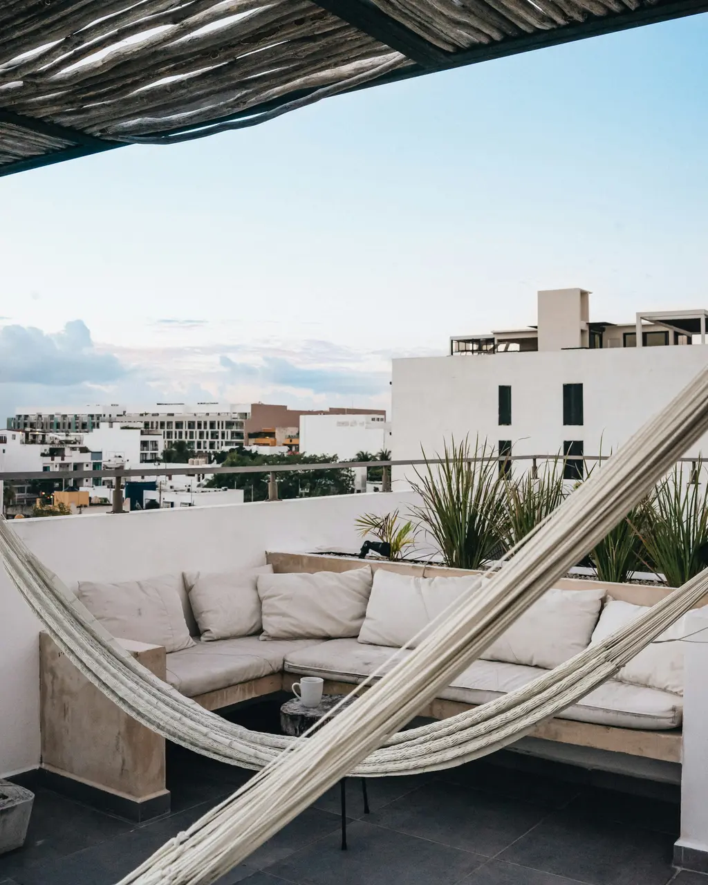 Rooftop terrace with hammock and outdoor lounge in Playa del Carmen