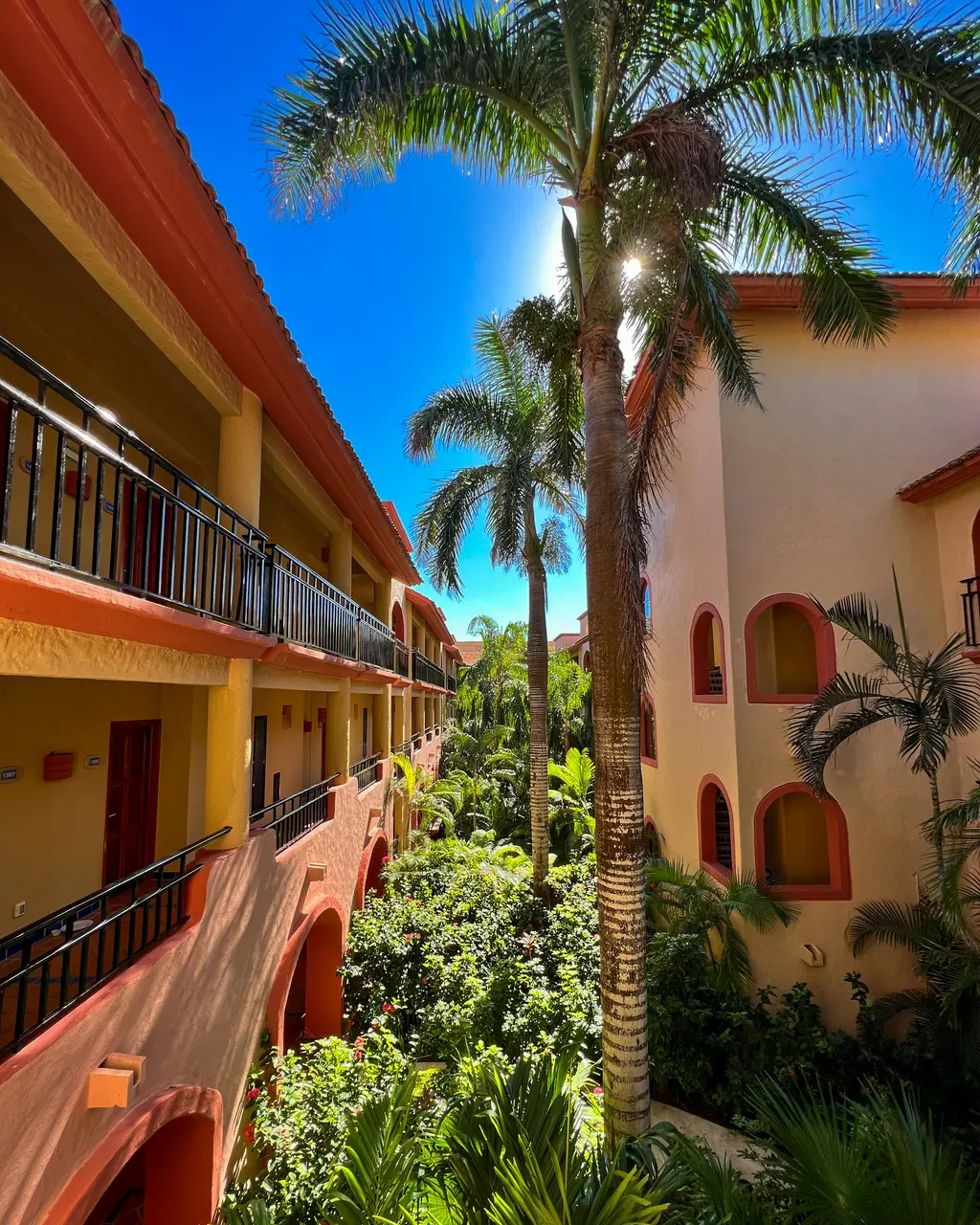 Balconied walkway with palm trees in a Mexican-style building in Playa del Carmen