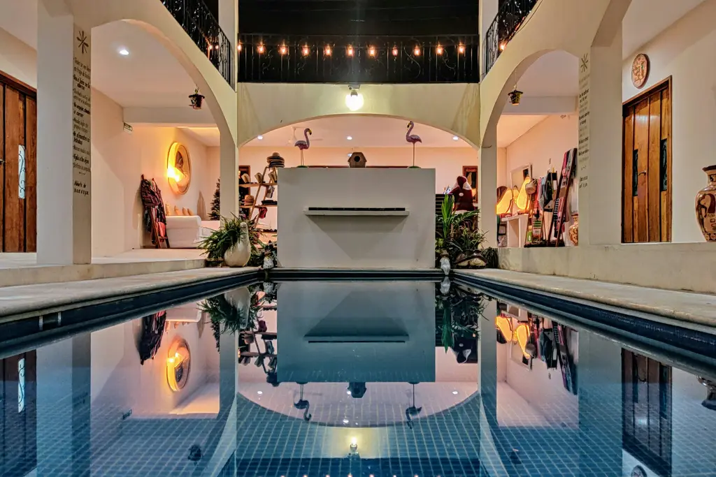 Inner courtyard with pool and lit arches in Tulum